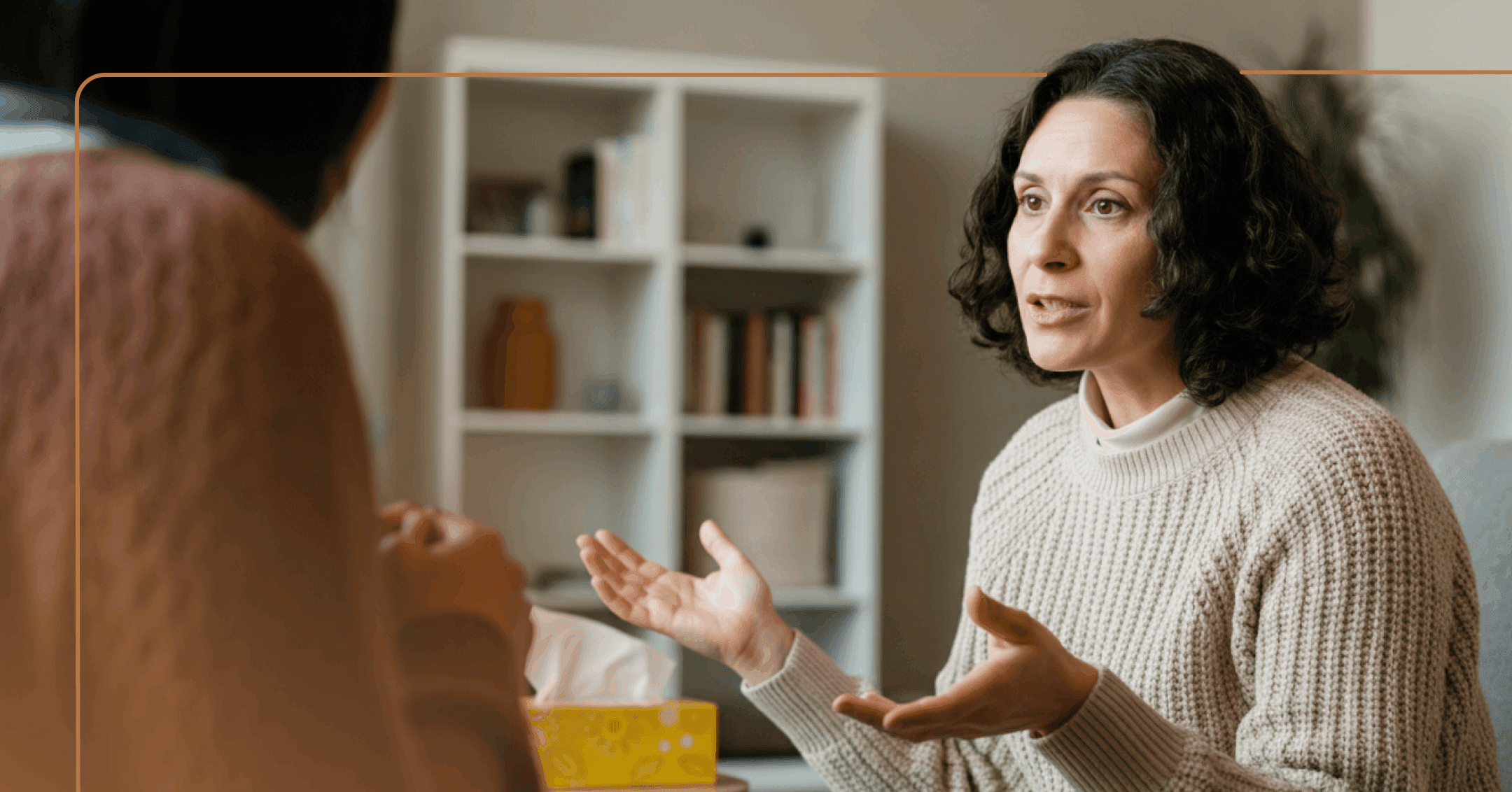 woman practicing cognitive behavioral therapy with therapist in their office